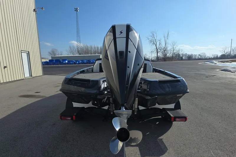 Slide: The Image of 2025 iKon LX21 boat rear view with powerful outboard motor in sunny outdoor setting. - 5