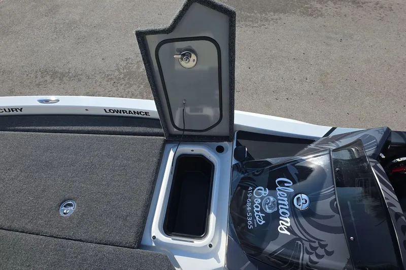 Slide: The Image of Open storage compartment on iKon LX21 boat, 2025 model, with Clemons Boats branding. - 8