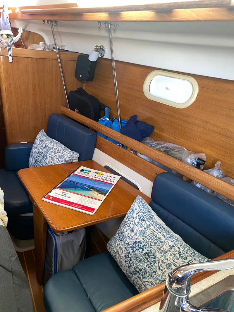 Slide: The Image of Interior of a 2003 Catalina 350 yacht with cozy seating area. - 16