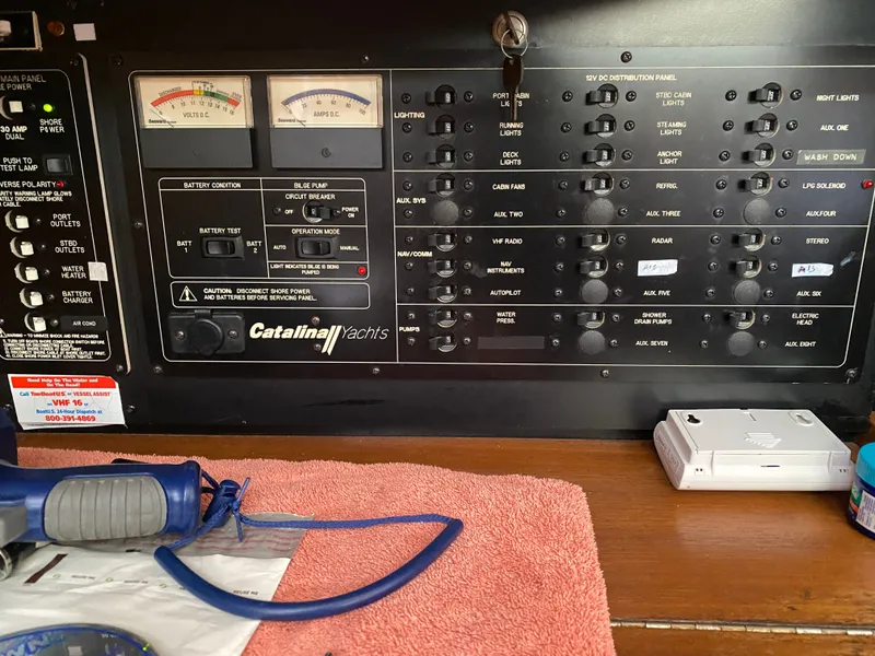 Slide: The Image of Catalina 350 yacht control panel with switches and gauges. - 18