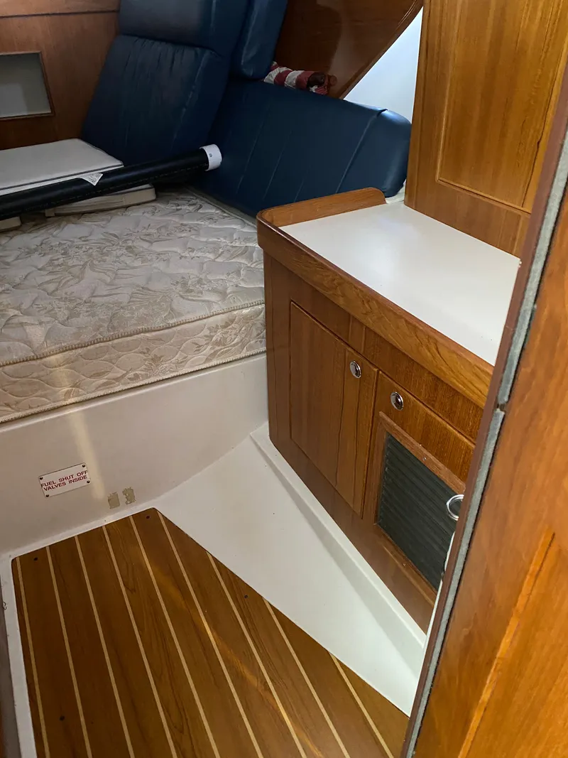 Slide: The Image of Interior of a 2003 Catalina 350 yacht with wooden flooring and bed. - 19