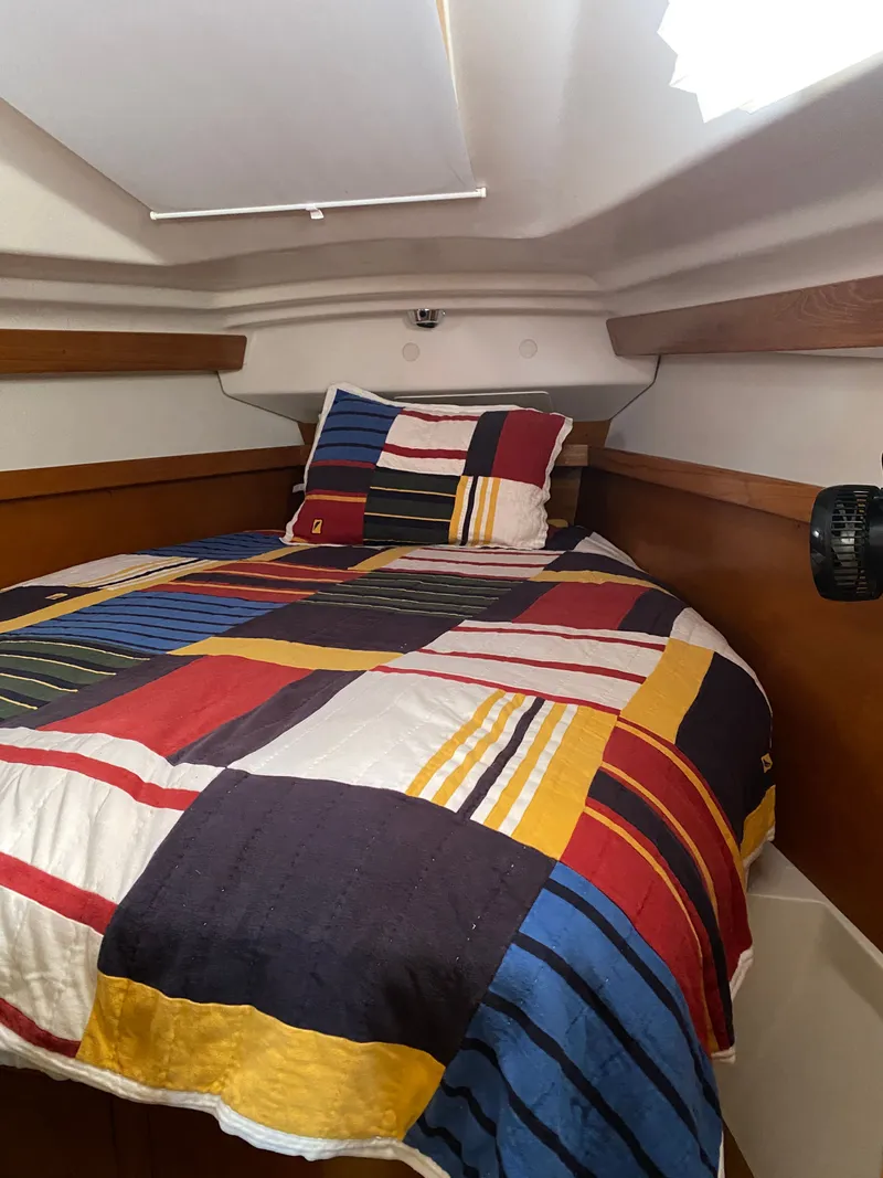 Slide: The Image of Interior of a 2003 Catalina 350 yacht with colorful bedding. - 24