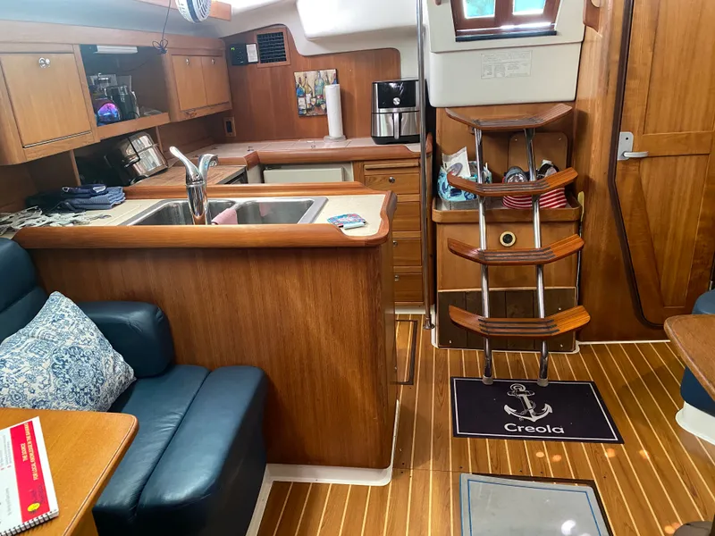 Slide: The Image of Interior of a 2003 Catalina 350 yacht with wooden furnishings. - 27