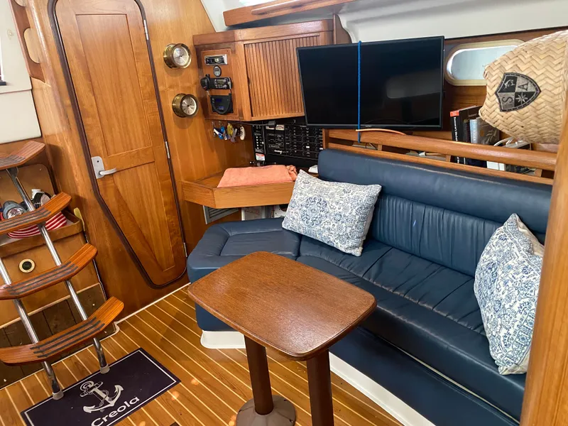 Slide: The Image of Interior of a 2003 Catalina 350 yacht with blue leather couch. - 28
