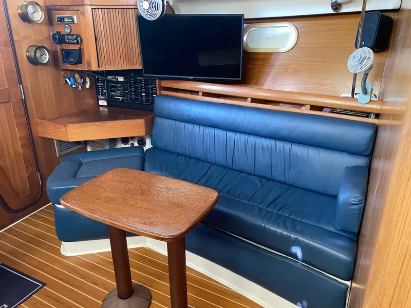 Slide: The Image of Interior of a 2003 Catalina 350 yacht with blue leather couch. - 31