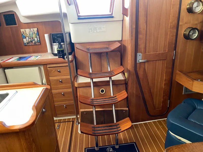 Slide: The Image of Interior of a 2003 Catalina 350 yacht with wooden stairs and cabinets. - 34