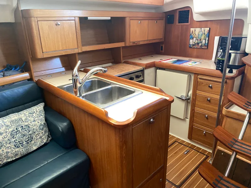 Slide: The Image of Interior of a 2003 Catalina 350 yacht with kitchen and seating area. - 36