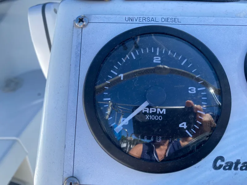 Slide: The Image of Tachometer of a 2003 Catalina 350, displaying 1680 RPM. - 39