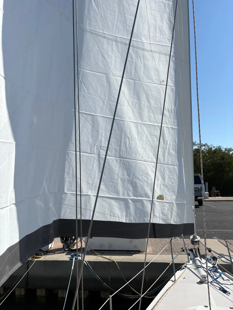 Slide: The Image of Catalina 350 sailboat with white sails, docked, 2003 model. - 42