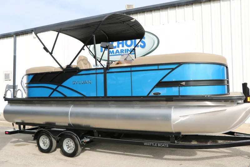 The Image of 2026 Sylvan Mirage 822 LZ pontoon boat with blue exterior and black canopy on trailer. - 0