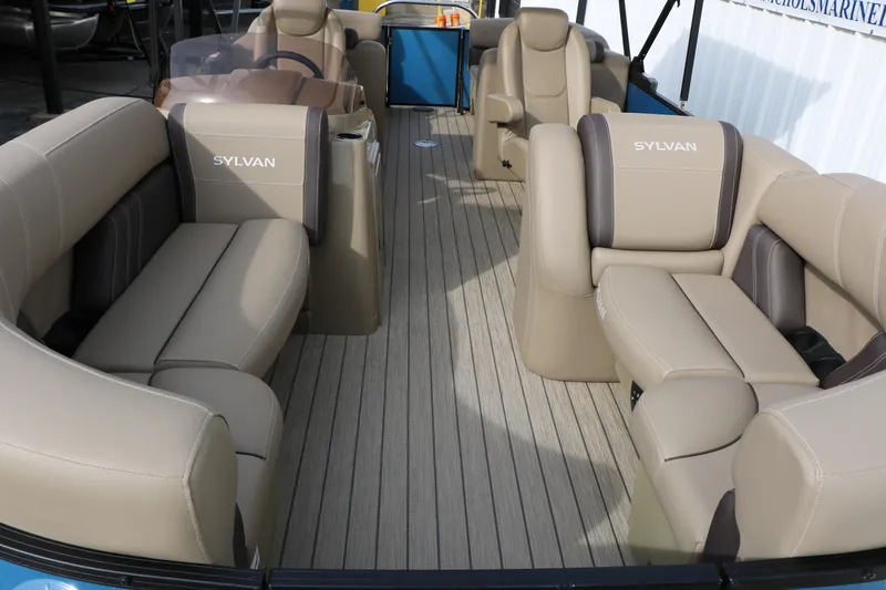 Slide: The Image of 2026 Sylvan Mirage 822 LZ pontoon boat interior with beige seating and steering console. - 13