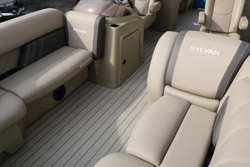 Slide: The Image of 2026 Sylvan Mirage 822 LZ boat interior with beige seating and sleek design. - 15