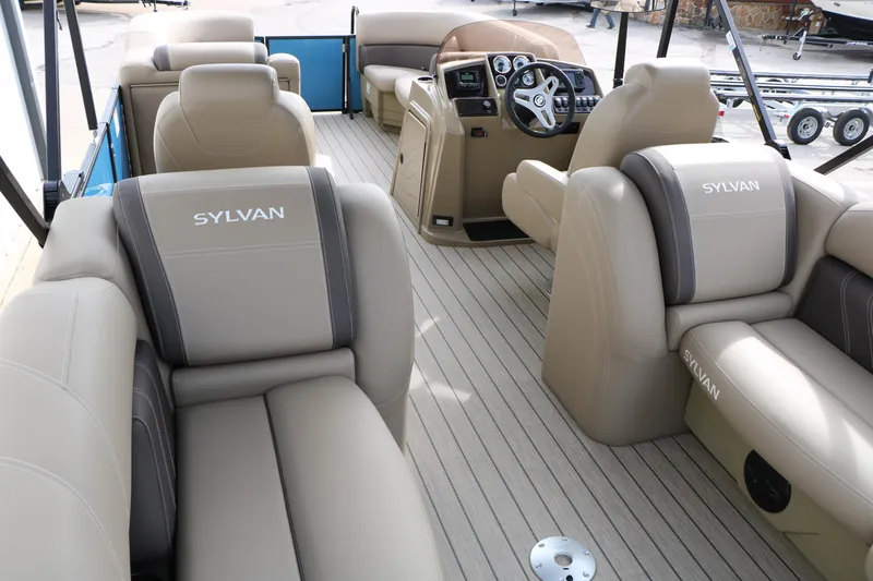 Slide: The Image of 2026 Sylvan Mirage 822 LZ pontoon boat interior with beige seating and steering console. - 17