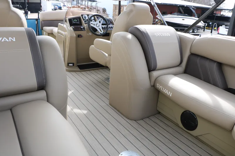 Slide: The Image of Interior of 2026 Sylvan Mirage 822 LZ pontoon boat with beige seating and steering console. - 22