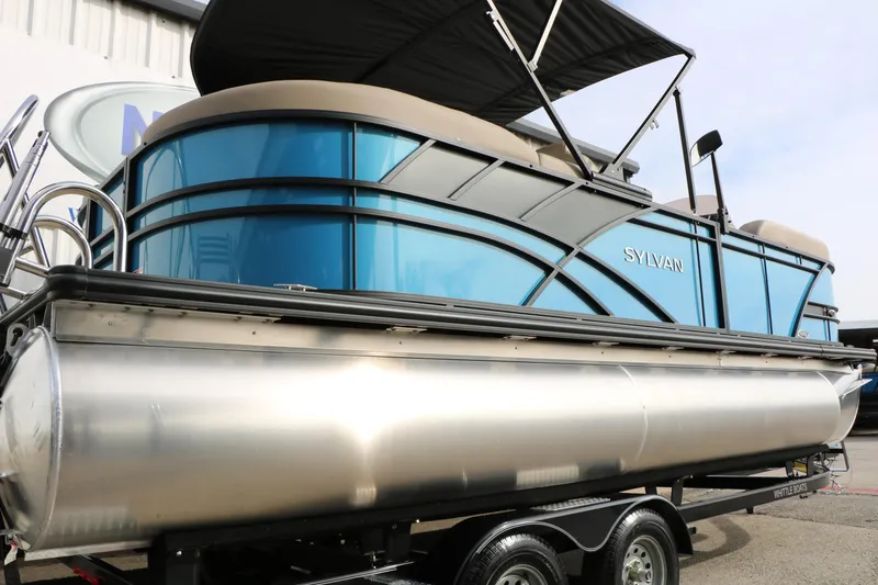 Slide: The Image of 2026 Sylvan Mirage 822 LZ pontoon boat with sleek blue design on trailer. - 6
