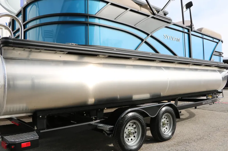 Slide: The Image of 2026 Sylvan Mirage 822 LZ pontoon boat on trailer, blue and silver design. - 7