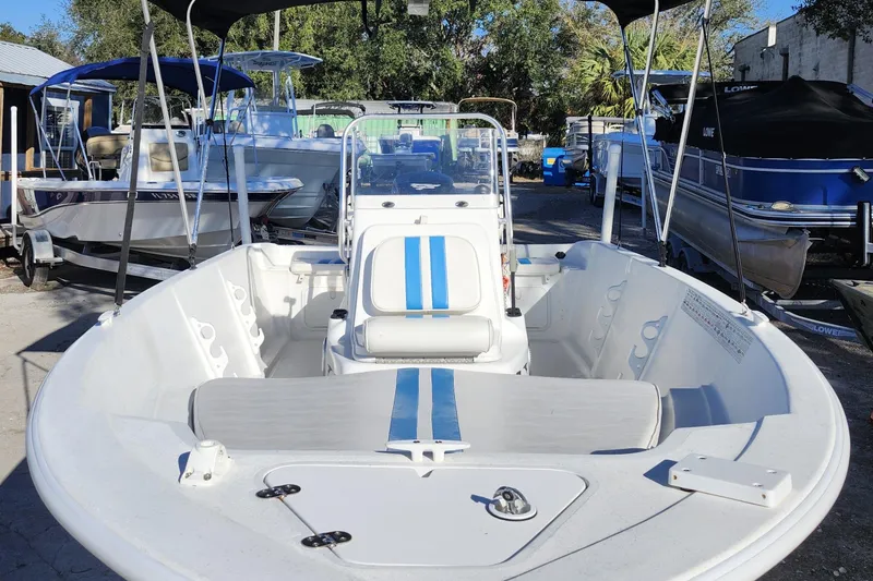 Slide: The Image of 2018 Glasstream 17 CCR boat with blue accents, docked among other boats. - 13