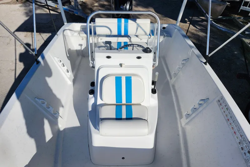 Slide: The Image of 2018 Glasstream 17 CCR boat interior with blue-striped seating and steering console. - 18