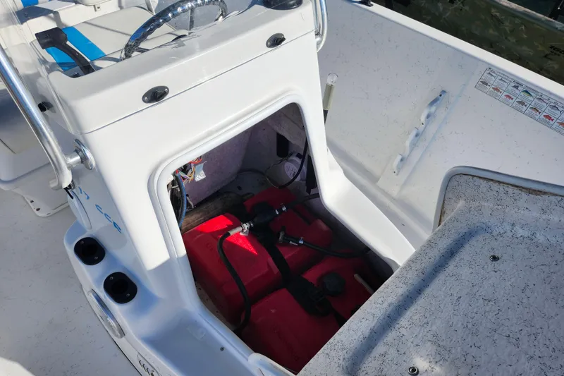 Slide: The Image of 2018 Glasstream 17 CCR boat interior showing storage compartment and steering console. - 19