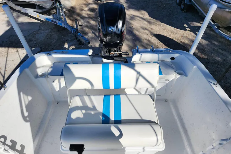Slide: The Image of 2018 Glasstream 17 CCR boat interior with blue-striped seating and outboard motor. - 24