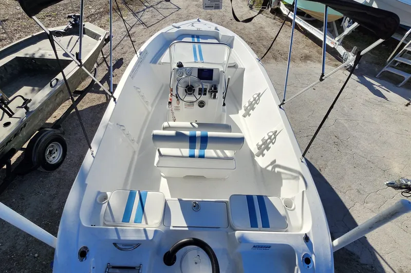 Slide: The Image of 2018 Glasstream 17 CCR boat interior with blue-striped seating and steering console. - 31