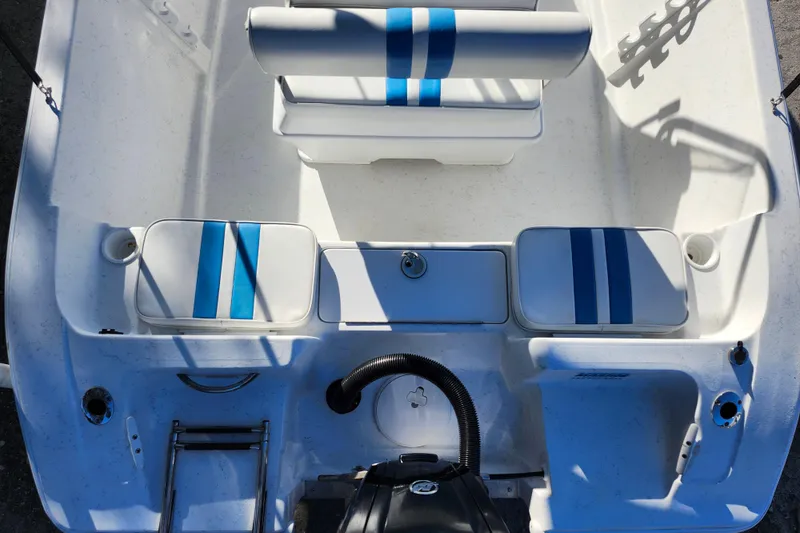 Slide: The Image of 2018 Glasstream 17 CCR boat interior with blue-striped seating and storage compartments. - 32