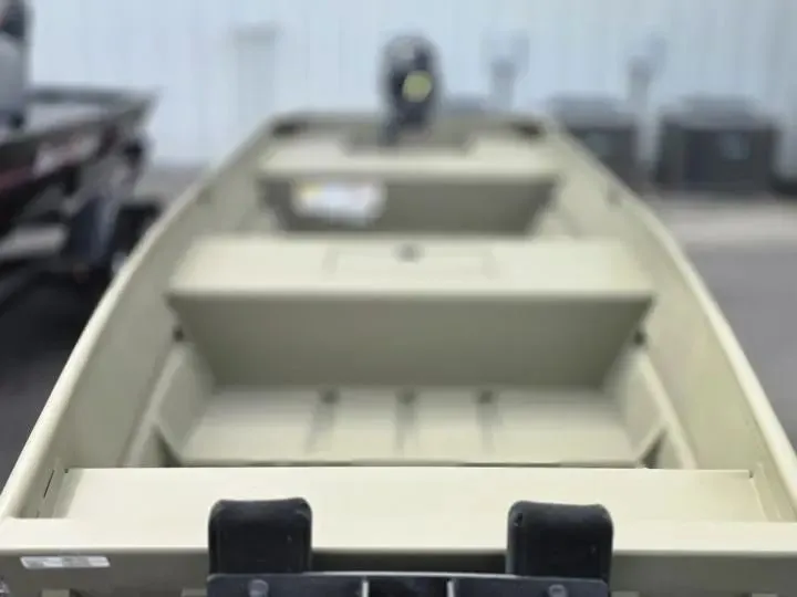Slide: The Image of Tracker Grizzly 15 Jon boat, 2026 model, in a boatyard. - 7