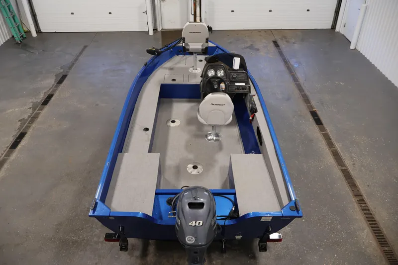 Slide: The Image of 2017 Polar Kraft Outlander 156 SC boat in a garage, featuring a blue exterior and Yamaha motor. - 10