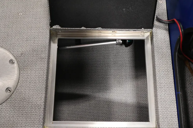 Slide: The Image of Open storage compartment on 2017 Polar Kraft Outlander 156 SC boat, featuring carpeted interior. - 16