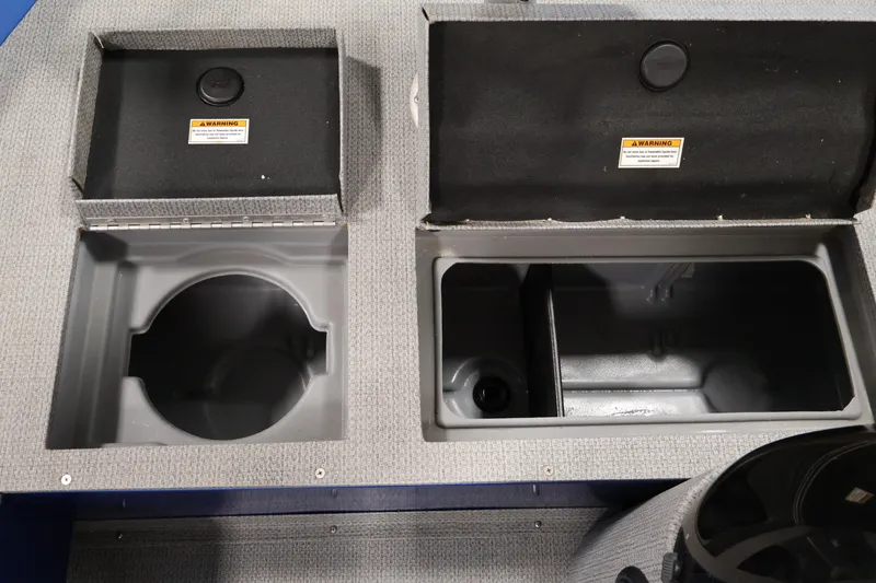 Slide: The Image of 2017 Polar Kraft Outlander 156 SC boat storage compartments, open with warning labels visible. - 18