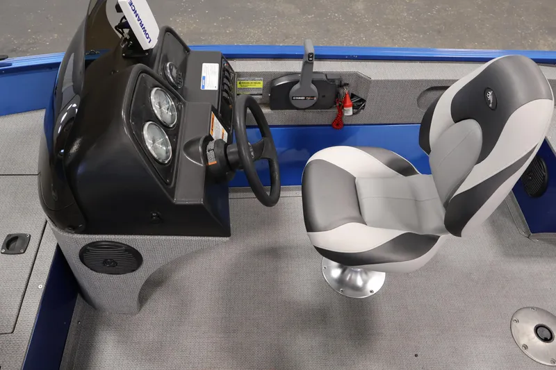 Slide: The Image of 2017 Polar Kraft Outlander 156 SC boat interior with steering console and cushioned seat. - 19