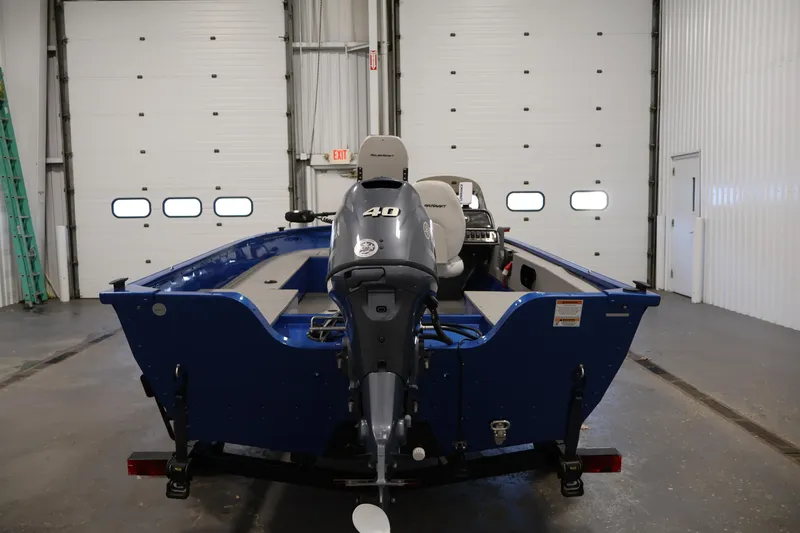 Slide: The Image of 2017 Polar Kraft Outlander 156 SC boat in a garage, featuring a 40 HP motor. - 6