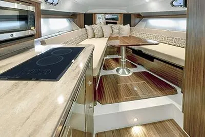 Slide: The Image of Luxurious interior of 2026 Pursuit OS 355 Offshore boat with modern kitchen and seating area. - 11
