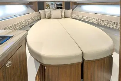 Slide: The Image of Luxurious interior of 2026 Pursuit OS 355 Offshore yacht with elegant bedding and wood finish. - 12