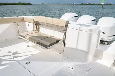Slide: The Image of 2026 Pursuit OS 355 Offshore boat deck with seating, ocean view, and triple outboard engines. - 5