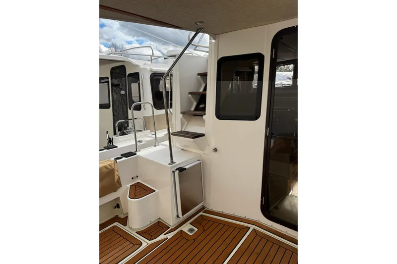 Slide: The Image of 2023 Ranger Tug R-31 CB interior with wooden flooring and modern design elements. - 12