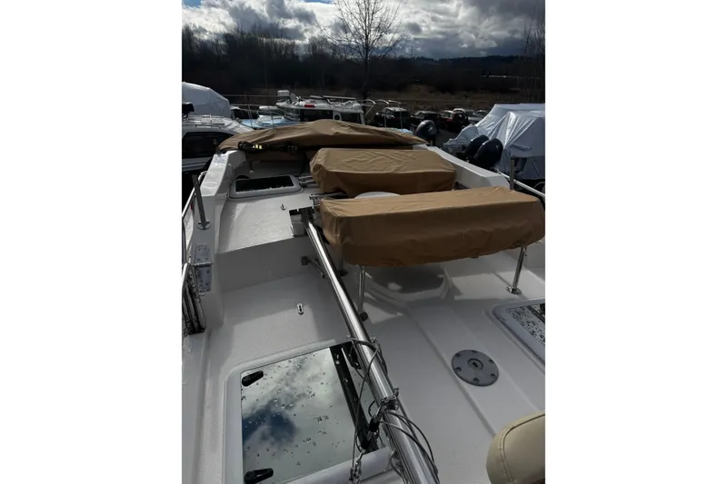 Slide: The Image of 2023 Ranger Tug R-31 CB boat deck with covered seating and equipment. - 15