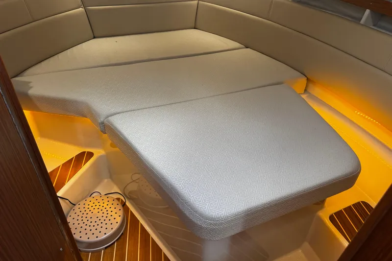 Slide: The Image of 2023 Ranger Tug R-31 CB interior cabin with cozy seating and warm lighting. - 20