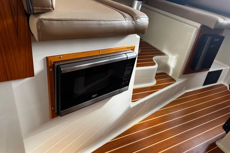 Slide: The Image of 2023 Ranger Tug R-31 CB interior with microwave and wooden flooring. - 6