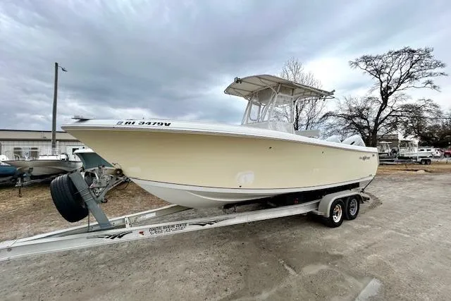 Slide: The Image of 2005 Sailfish 266 CC boat on trailer under cloudy sky. - 1
