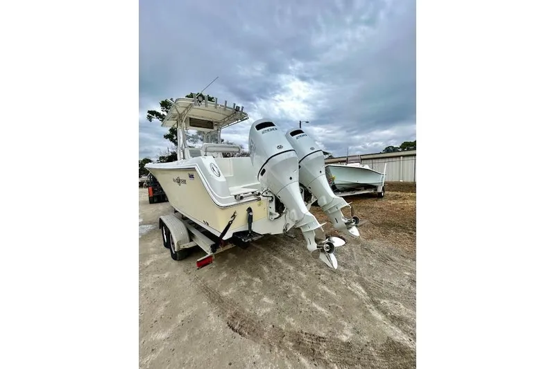 Slide: The Image of 2005 Sailfish 266 CC boat with dual outboard engines on a trailer. - 3