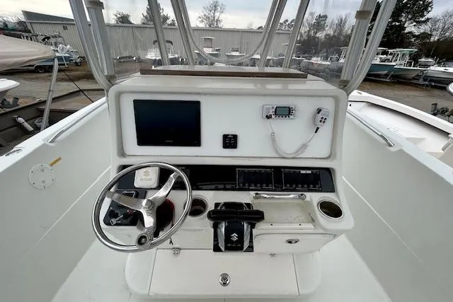 Slide: The Image of Center console of 2005 Sailfish 266 CC boat with steering wheel and navigation equipment. - 7