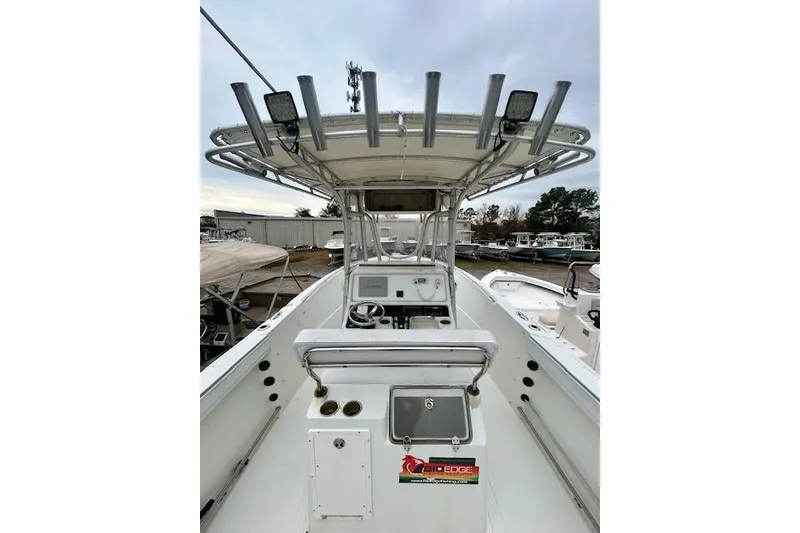 Slide: The Image of 2005 Sailfish 266 CC boat interior with helm, rod holders, and seating. - 8