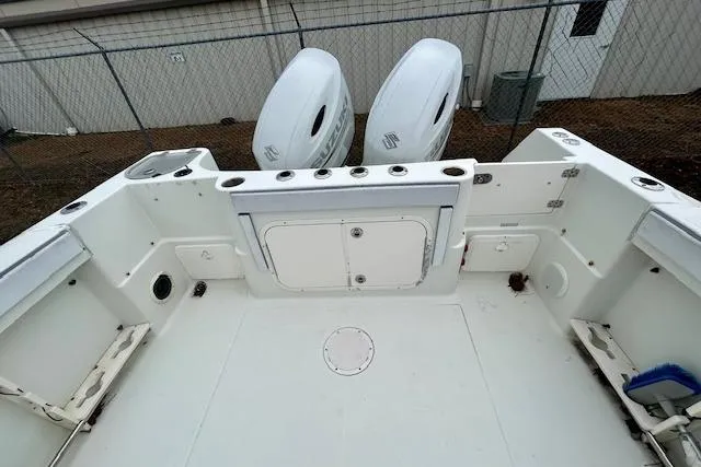 Slide: The Image of 2005 Sailfish 266 CC boat deck with dual outboard motors and storage compartments. - 5