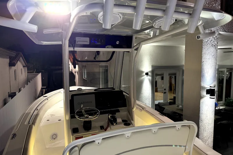 Slide: The Image of 2024 Sea Hunt Ultra 239 SE boat interior with illuminated console and Garmin navigation system. - 10