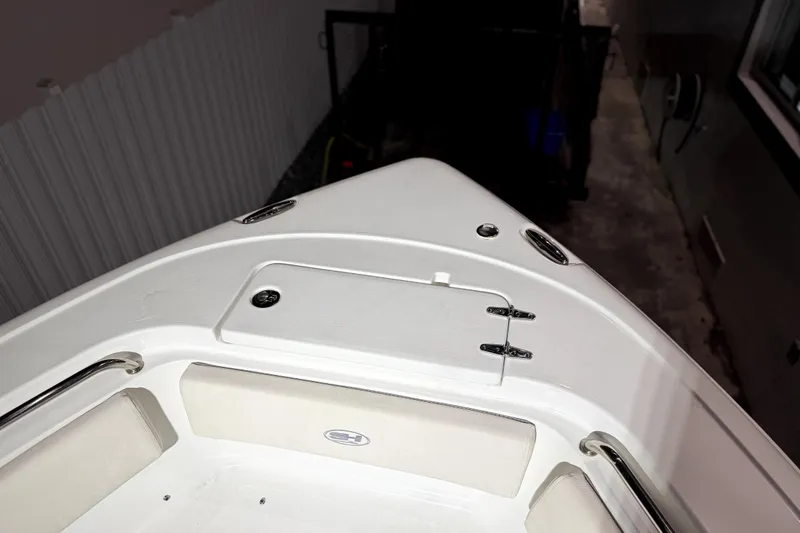 Slide: The Image of 2024 Sea Hunt Ultra 239 SE boat bow with storage compartment and seating. - 13