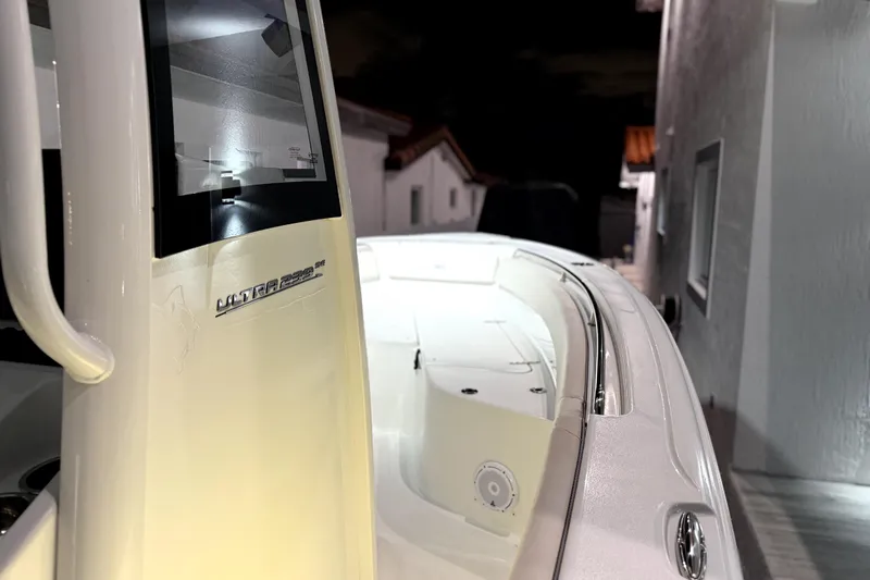 Slide: The Image of 2024 Sea Hunt Ultra 239 SE boat, side view at night, showcasing sleek design. - 17