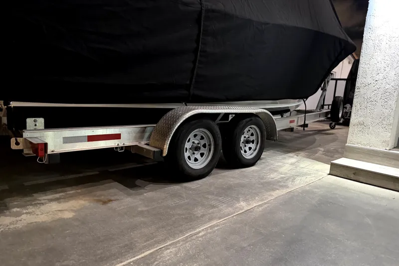 Slide: The Image of 2024 Sea Hunt Ultra 239 SE boat on trailer, covered, in a garage. - 5