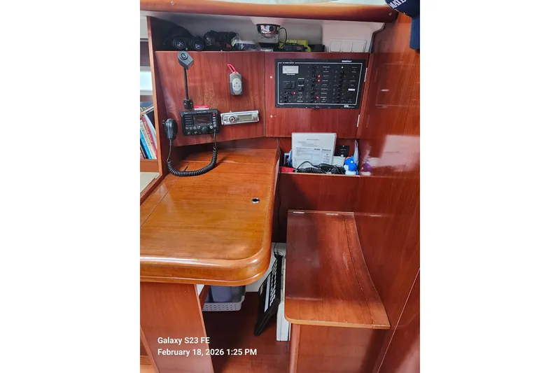 Slide: The Image of Navigation station of 2005 Beneteau Oceanis Clipper 393 yacht with communication equipment. - 14