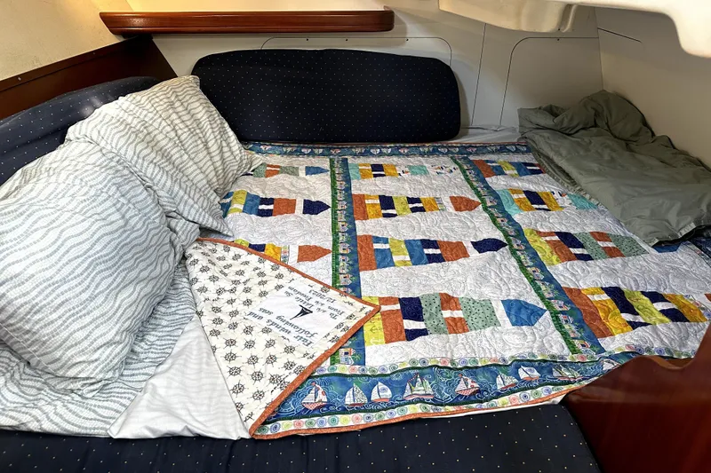 Slide: The Image of Cozy cabin bed in 2005 Beneteau Oceanis Clipper 393 with colorful nautical quilt. - 17